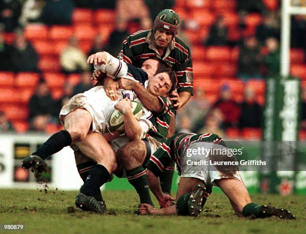 Scott Gibbbs of Swansea is stopped by Pat Howard and Ben Kay of Leicester during the match between Leicester Tigers and Swansea in the Heineken Cup...