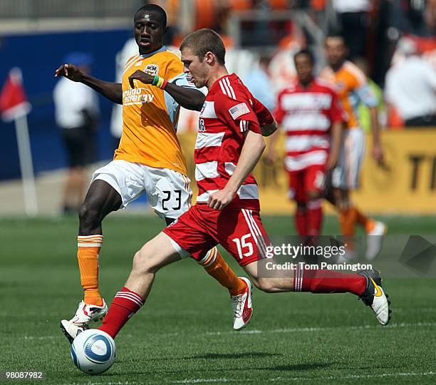 Defender Kyle Davies of FC Dallas moves the ball against forward Dominic Oduro of the Houston Dynamo during a MLS game at Pizza Hut Park on March 27,...