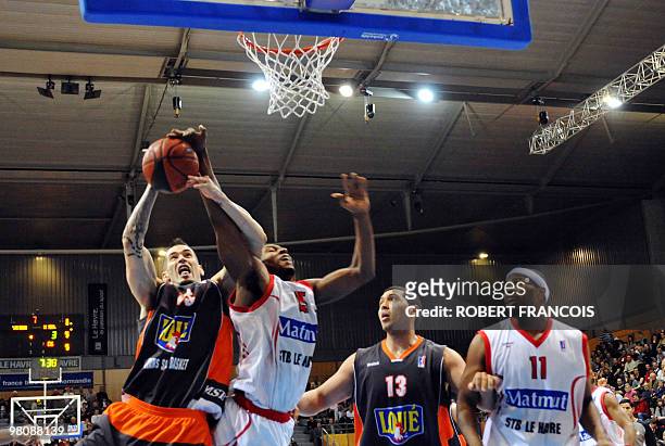 Le Mans's Henri Kahudit and Guillaume Yango vie with Le Havre' forward Odartey Blankson and Joseph Jones during their French ProA basketball match on...