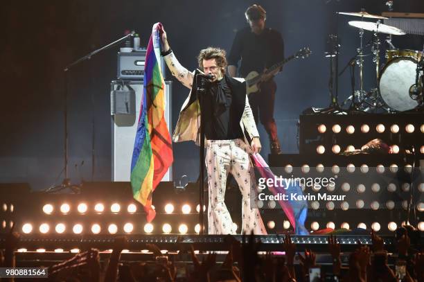 Harry Styles holds rainbow flags as he performs onstage during Harry Styles: Live On Tour - New York at Madison Square Garden on June 21, 2018 in New...
