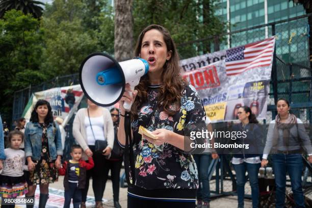 Protester holds a megaphone as she speaks during a 'Families Belong Together' rally outside the U.S. Embassy in Mexico City, Mexico, on Thursday,...