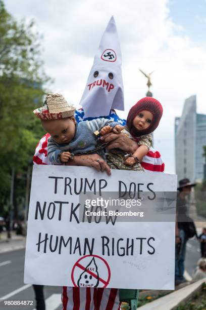 Protester holds a placard during a 'Families Belong Together' rally outside the U.S. Embassy in Mexico City, Mexico, on Thursday, June 21, 2018....