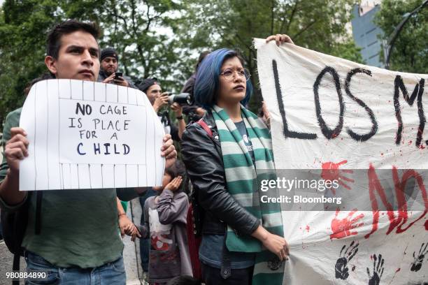 Protesters hold placards during a 'Families Belong Together' rally outside the U.S. Embassy in Mexico City, Mexico, on Thursday, June 21, 2018....