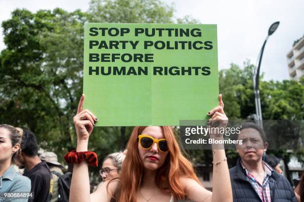 Protester holds placard during a 'Families Belong Together' rally outside the U.S. Embassy in Mexico City, Mexico, on Thursday, June 21, 2018....