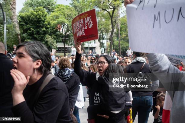 Protesters shout slogans and hold placards during a 'Families Belong Together' rally outside the U.S. Embassy in Mexico City, Mexico, on Thursday,...