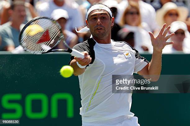 Marcos Baghdatis of Cyprus returns a shot against Juan Ignacio Chela of Argentina during day five of the 2010 Sony Ericsson Open at Crandon Park...