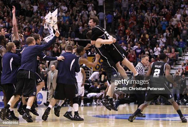 Matt Howard of the Butler Bulldogs leaps into the arms Andrew Smith as they celebrate defeating the Kansas State Wildcats in the west regional final...