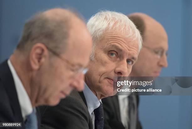 March 2018, Germany, Stuttgart: Hans Dieter Poetsch , chairman of the executive board of Porsche SE; Matthias Mueller, CEO of Volkswagen AG; and...