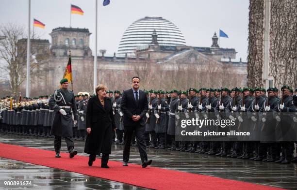 March 2018, Germany, Berlin: German Chancellor Angela Merkel receives Irish Prime Minister Leo Varadkar, with military honours at the German...