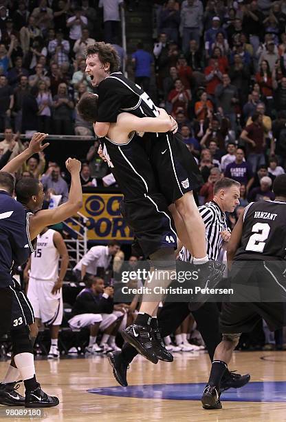 Matt Howard of the Butler Bulldogs leaps into the arms Andrew Smith as they celebrate defeating the Kansas State Wildcats in the west regional final...