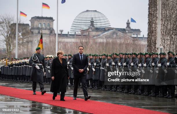 Dpatop - Irish Taoiseach Leo Varadkar and German Chancellor Angela Merkel inspect the guard of honour during a welcome ceremony at the Chancellery in...