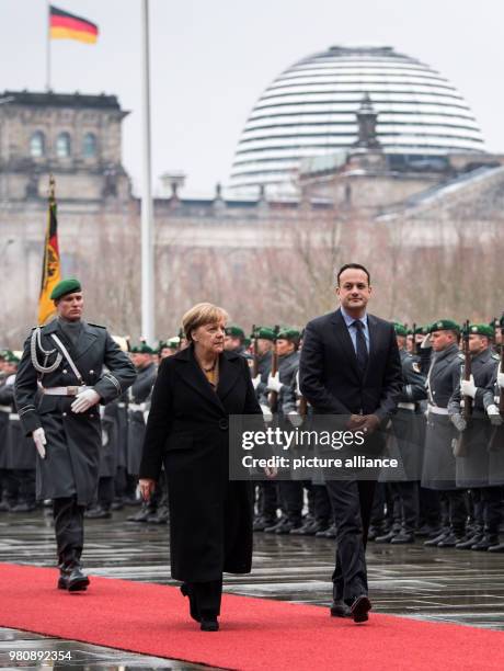 March 2018, Germany, Berlin: German Chancellor Angela Merkel receives Irish Prime Minister Leo Varadkar with military honours at the German...