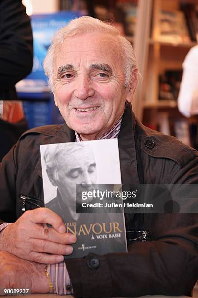 Singer Charles Aznavour signs copies of his book ''A voix basse'' at the 30th salon du livre at Porte de Versailles on March 27, 2010 in Paris,...