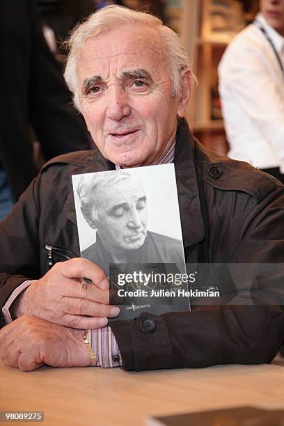 Singer Charles Aznavour signs copies of his book ''A voix basse'' at the 30th salon du livre at Porte de Versailles on March 27, 2010 in Paris,...