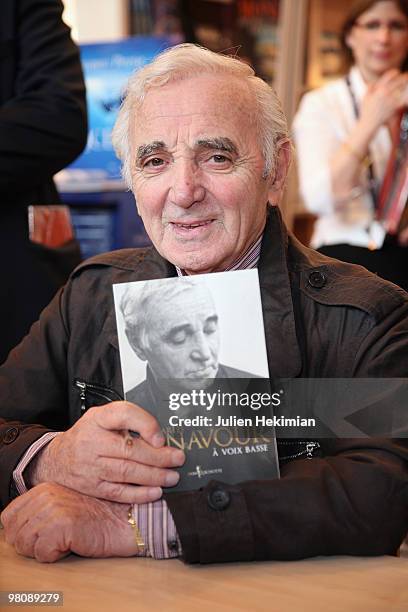 Singer Charles Aznavour signs copies of his book ''A voix basse'' at the 30th salon du livre at Porte de Versailles on March 27, 2010 in Paris,...