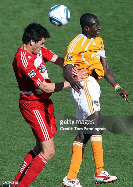 Defender George John of FC Dallas heads the ball against forward Dominic Oduro of the Houston Dynamo during a MLS game at Pizza Hut Park on March 27,...