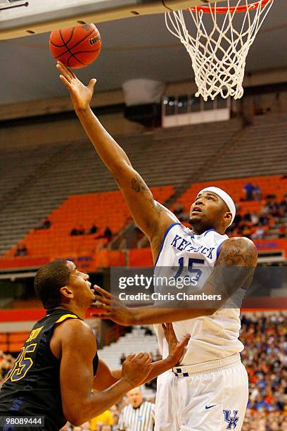 DeMarcus Cousins of the Kentucky Wildcats attempts a shot against Wellington Smith of the West Virginia Mountaineers during the east regional final...