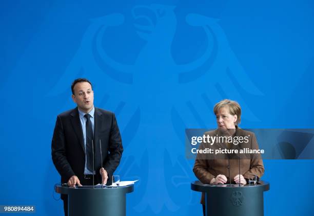 March 2018, Germany, Berlin: German Chancellor Angela Merkel and Irish Prime Minister Leo Varadkar speaking at a press conference after their meeting...