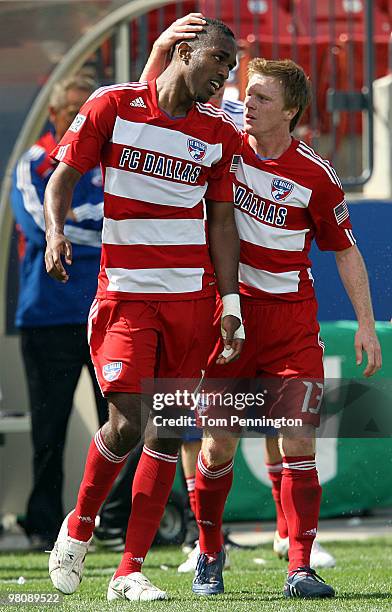 Midfielder Dax McCarty of FC Dallas congratulates forward Atiba Harris after Harris scored the game tying goal against the Houston Dynamo during a...