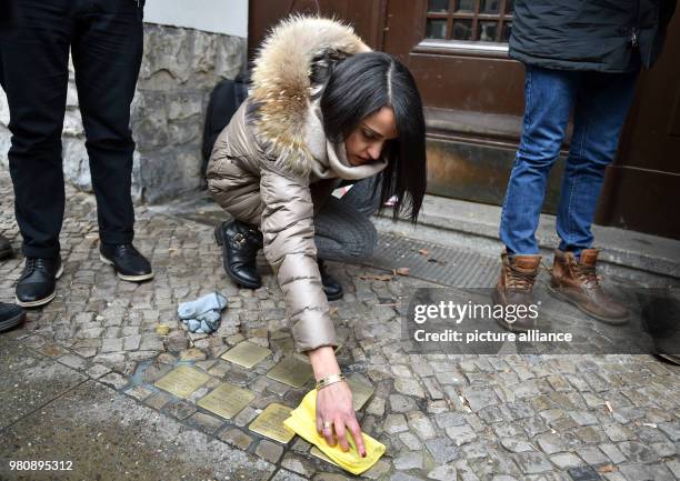 March 2018, Germany, Berlin: Sawsan Chebli, state secretary in Berlin, cleaning stumbling blocks with fellow citizens. She started a call for the...
