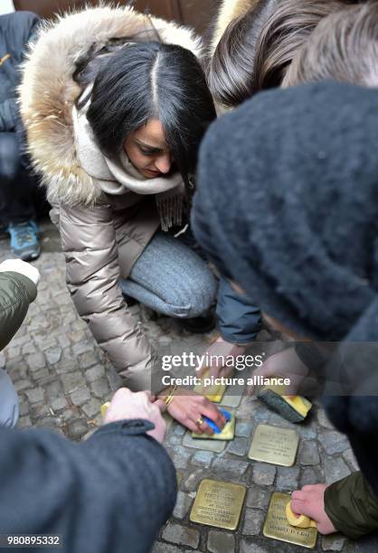 March 2018, Germany, Berlin: Sawsan Chebli, state secretary in Berlin, cleaning stumbling blocks with fellow citizens. She started a call for the...