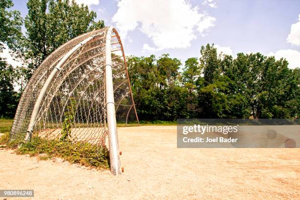 faded backstop and sandlot--july 17, 2014 - backstop foto e immagini stock