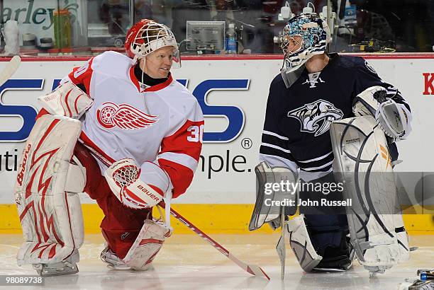 Chris Osgood of the Detroit Red Wings talks with Dan Ellis of the Nashville Predators during warmups on March 27, 2010 at the Bridgestone Arena in...