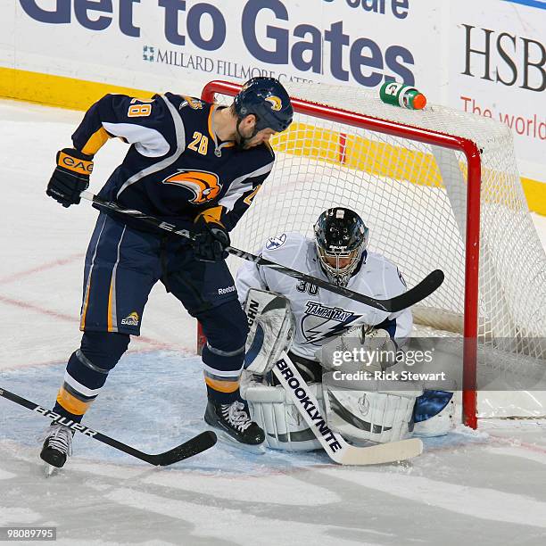 Paul Gaustad of the Buffalo Sabres watches his shot roll over the glove of Antero Niittymaki of the Tampa Bay Lightning and into the goal for his...