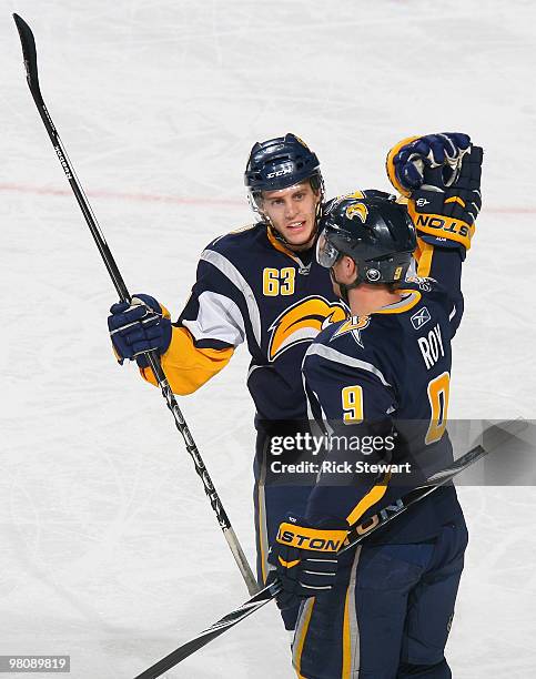 Tyler Ennis and Derek Roy of the Buffalo Sabres celebrate Roy's goal in the first period against the Tampa Bay Lightning at HSBC Arena on March 27,...