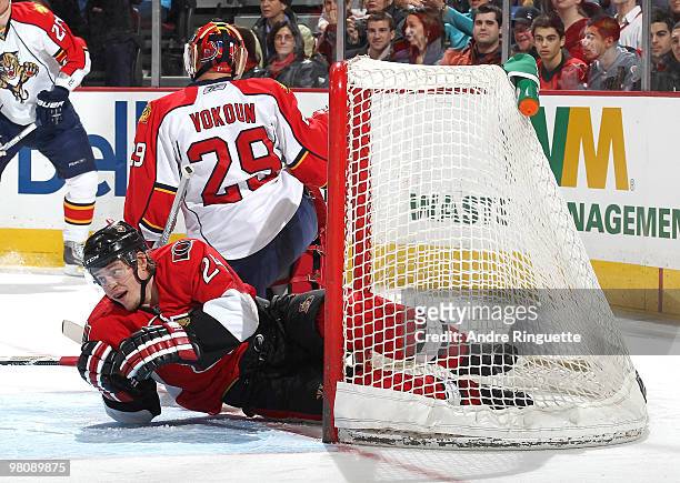 Anton Volchenkov of the Ottawa Senators looks up after crashing into the net behind Tomas Vokoun of the Florida Panthers at Scotiabank Place on March...