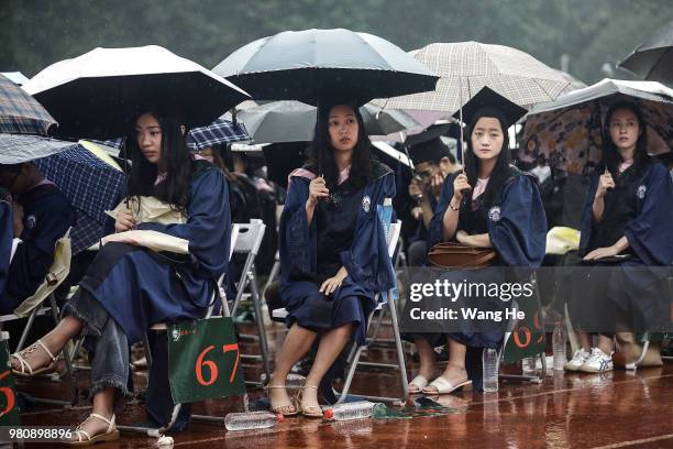 The graduates carry umbrellas during their ceremony of Wuhan University on June 22, 2018 in Wuhan, China.China is forecast to produce 8.2 million...