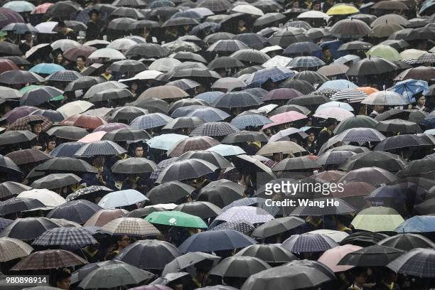 Ten thousand graduates carry umbrellas during their ceremony of Wuhan University on June 22, 2018 in Wuhan, China.China is forecast to produce 8.2...