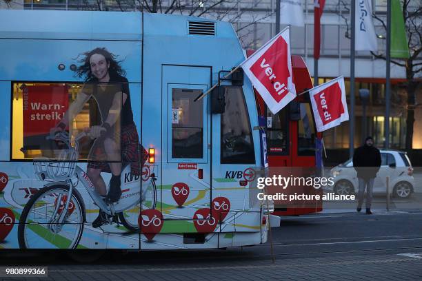 March 2018, Germany, Cologne: Trams with verdi flags parked outside the Koelner Verkehrsbetriebe depot. The Verdi union has called warning strikes in...