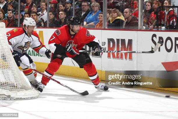 Matt Cullen of the Ottawa Senators stickhandles the puck as Keith Ballard of the Florida Panthers chases behind the net at Scotiabank Place on March...