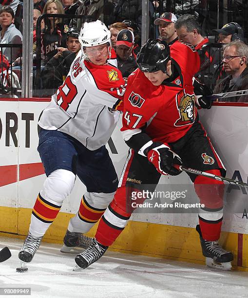 Zack Smith of the Ottawa Senators gets tangled up with Kamil Kreps of the Florida Panthers while digging for the puck along the boards at Scotiabank...
