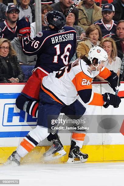 Matt Moulson of the New York Islanders checks Derick Brassard of the Columbus Blue Jackets into the glass during the first period on March 27, 2010...