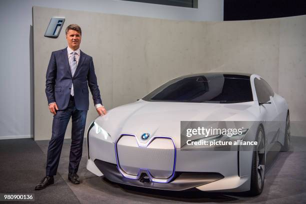 March 2018, Germany, Munich: Harald Krueger, CEO at carmaker BMW, standing beside a BMW i Vision Dynamics concept car before the BMW annual results...