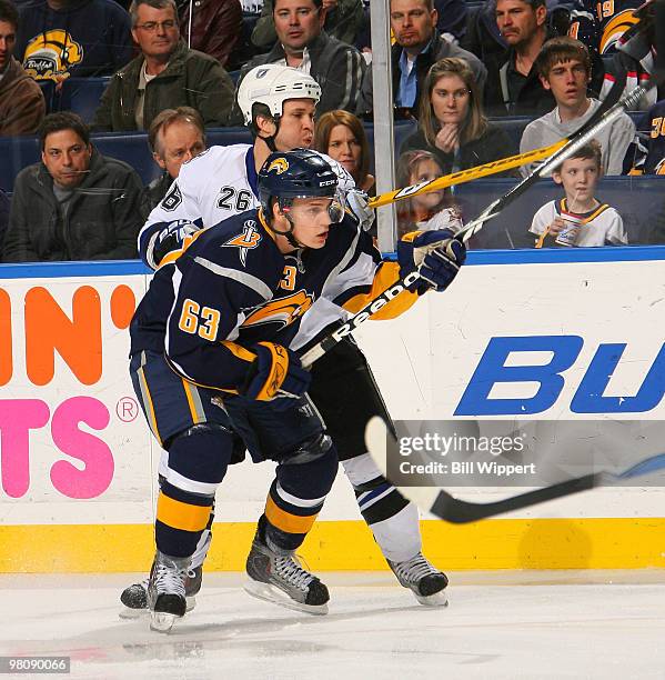 Tyler Ennis of the Buffalo Sabres and Martin St. Louis of the Tampa Bay Lightning chase after the puck in the first period on March 27, 2010 at HSBC...