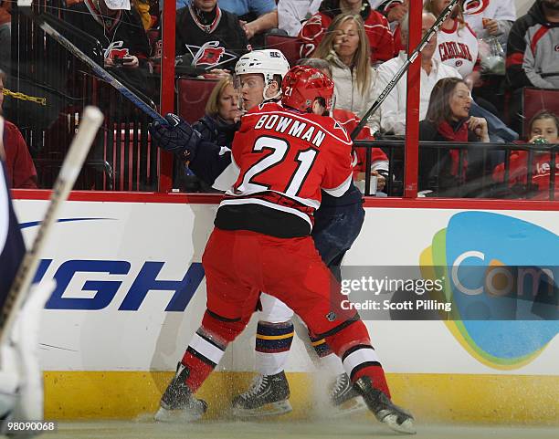 Tobias Enstrom of the Atlanta Thrashers gets smashed against the boards by Drayson Bowman of the Carolina Hurricanes during their NHL game on March...