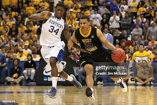 Joe Mazzulla of the West Virginia Mountaineers drives against DeAndre Liggins of the Kentucky Wildcats during the east regional final of the 2010...