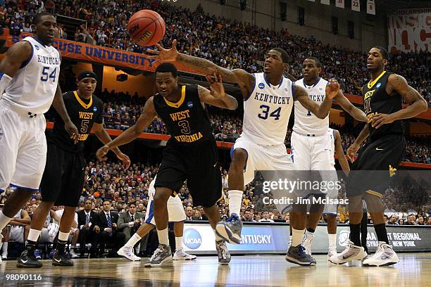 DeAndre Liggins of the Kentucky Wildcats reaches for a loose ball against Devin Ebanks of the West Virginia Mountaineers during the east regional...