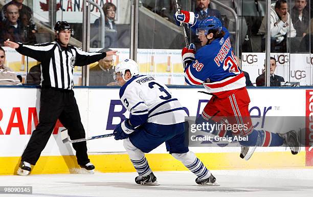 Dion Phaneuf of the Toronto Maple Leafs checks P.A. Parenteau of the New York Rangers during game action March 27, 2010 at the Air Canada Centre in...