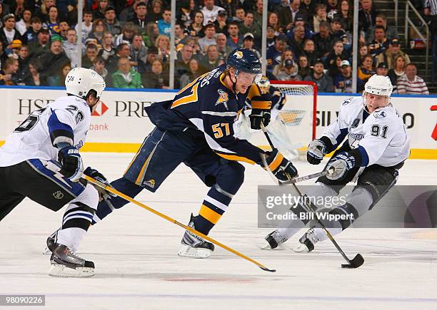 Tyler Myers of the Buffalo Sabres carries the puck past Martin St. Louis and Steven Stamkos of the Tampa Bay Lightning on March 27, 2010 at HSBC...