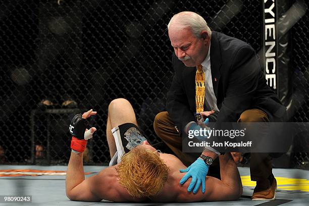 The UFC fight doctor checks on UFC fighter Matthew Riddle after he was kicked in the face by Greg Soto during their Welterweight bout at UFC 111 at...