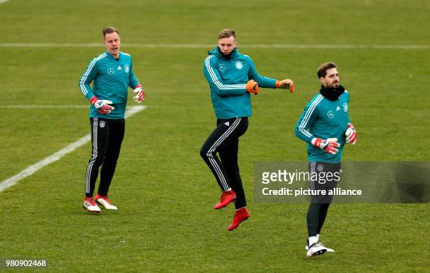 March 2018, Germany, Duesseldorf: Germany team training session: Goalies Marc-Andre ter Stegen, Bernd Leno and Kevin Trapp warming up. Germany are...