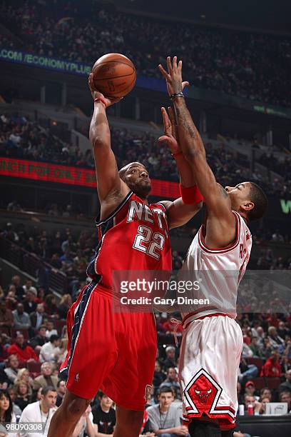 Jarvis Hayes of the New Jersey Nets shoots a layup against Derrick Rose of the Chicago Bulls on March 27, 2010 at the United Center in Chicago,...