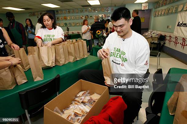 Yao Ming of the Houston Rockets helps fill hygiene bags for the homeless on March 26, 2010 at the SEARCH Homeless Shelter in Houston, Texas. NOTE TO...