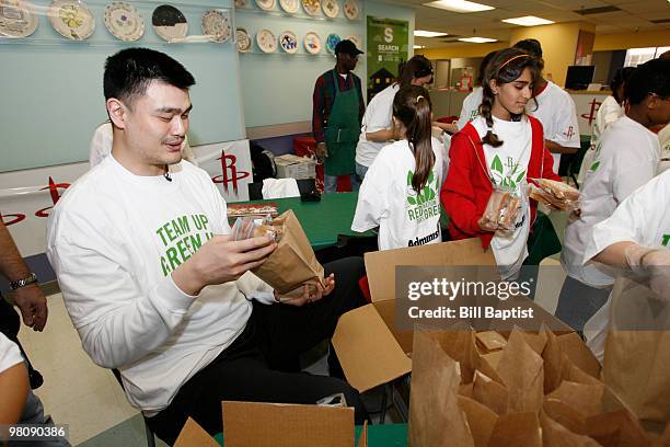 Yao Ming of the Houston Rockets helps fill hygiene bags for the homeless on March 26, 2010 at the SEARCH Homeless Shelter in Houston, Texas. NOTE TO...