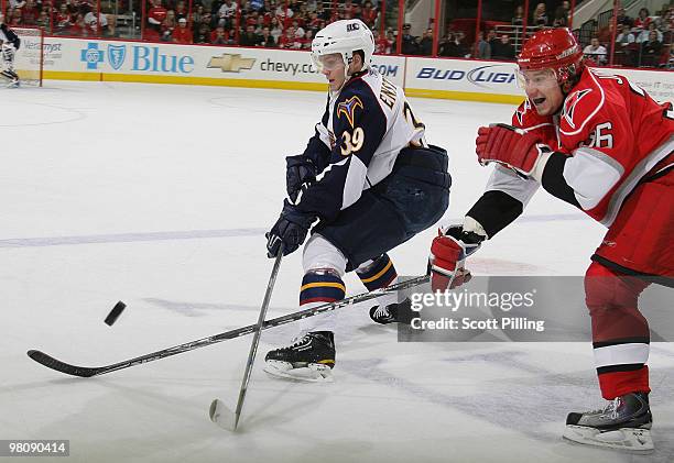 Tobias Enstrom of the Atlanta Thrashers battles for possesion of the puck with Jussi Jokinen of the Carolina Hurricanes during their NHL game on...