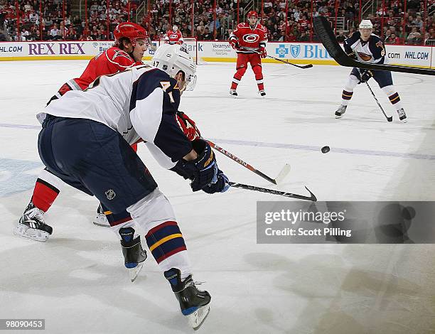 Zach Boychuk of the Carolina Hurricanes fights for the puck against Rich Peverley of the Atlanta Thrashers during their NHL game on March 27, 2010 at...